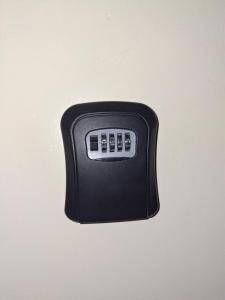 a black remote control sitting on top of a table at Lymak 2 Bedroom Hilltop Ngong in Ngong