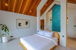 a bedroom with a bed and a glass shower at Villa Kanu in Uluwatu +22 photos