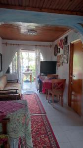 a living room with a bed and a table at Private Room Near Palioura Epanomis in Epanomi