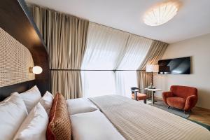Postel nebo postele na pokoji v ubytování Hotel Palais Mailberger Hof + 37 fotografií