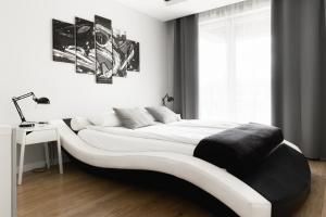 a bedroom with a large white bed in a room at Prestige Apartaments 79 in Wrocław