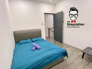 a bedroom with a bed and a sign on the wall at Staycation Homestay 15 Kch City Mall Landed House in Kuching