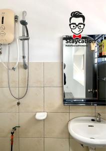 a bathroom with a shower and a sink and a mirror at Staycation Homestay 15 Kch City Mall Landed House in Kuching +32 photos