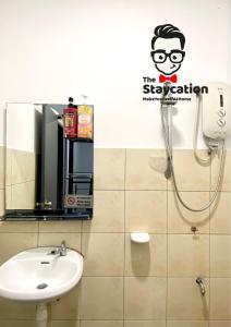 a bathroom with a shower and a sink at Staycation Homestay 15 Kch City Mall Landed House in Kuching