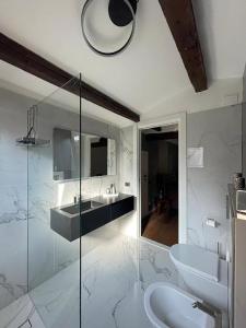 a bathroom with a sink and a glass shower at Ca' ai Sospiri in Venice +48 photos