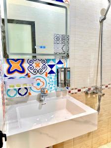 a bathroom with a white sink and a mirror at THU HA SEA VIEW Hotel in Cat Ba +34 photos
