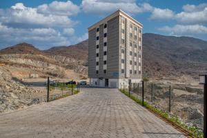 a building in the middle of a mountain at Khorfakan homes by the Living in Khor Fakkan