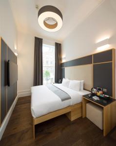 a hotel room with a large bed and a window at The Z Hotel Gloucester Place in London