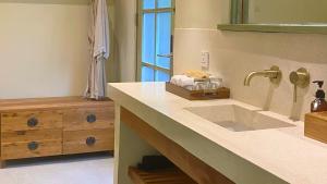 a bathroom with a sink and a mirror at White Penny Hostel in Seminyak +30 photos