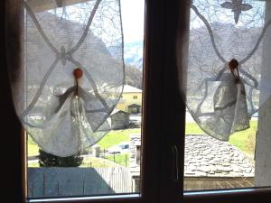a window with a view of a mountain view at Casa In Borgo in Caspoggio