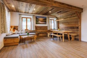 un salon avec un canapé et une table dans l'établissement Aschenauer Hof, à Ruhpolding