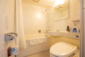 a bathroom with a toilet and a sink and a tub at Albert Hotel in Akita +117 photos