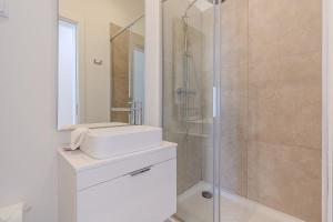 a bathroom with a sink and a shower at Downtown Studio Apartment G - 150m from the Beach in Albufeira +41 photos