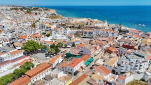 an aerial view of a city with buildings and the ocean at Downtown Studio Apartment G - 150m from the Beach in Albufeira