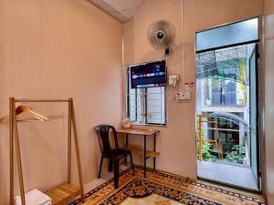 a room with a desk and a chair and a window at 1979 Homestay 2 in Hue