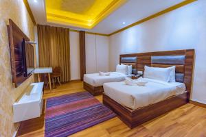 Ένα ή περισσότερα κρεβάτια σε δωμάτιο στο Hotel Melody
