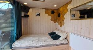 a small bed in a room with a window at 2me2 - getaway in Värati in Värati