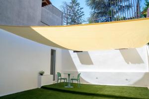 a room with a table and chairs on the grass at Suite Holiday Preziosa in Vieste