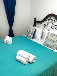 a bed with towels and pillows on it at La Perla House in Anacapri
