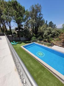 a swimming pool in a yard with grass at Casa ESPLIEGO in Torrelodones