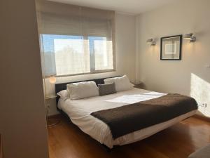 a bedroom with a large bed with a window at Casa Libao in Arrieta +40 photos