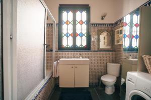 a bathroom with a toilet and stained glass windows at Dar Rania in Tangier +39 photos