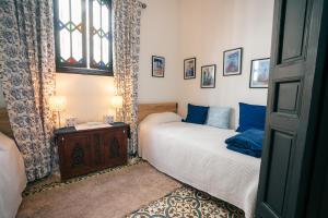 a bedroom with two beds and a window at Dar Rania in Tangier