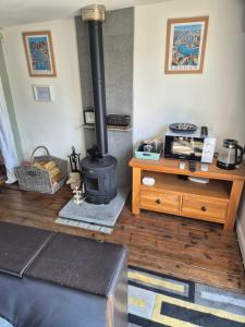 a living room with a stove and a wooden floor at West Lodge in Hatfield
