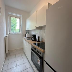 a kitchen with white cabinets and a stove top oven at WDI - WorkersDream 2 in Krefeld