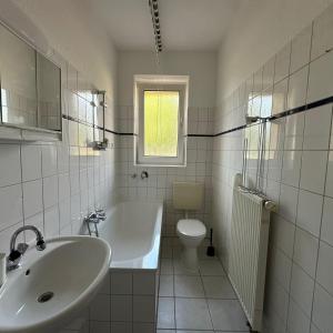 a bathroom with a sink and a tub and a toilet at WDI - WorkersDream 2 in Krefeld