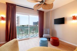 a living room with a large window with a balcony at tent Mojito Suites in Magaluf