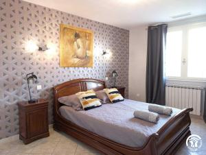 a bedroom with a bed with pillows on it at La gineroise in Le Grau-dʼAgde +35 photos