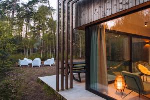 a house with a view of a patio with chairs at Knuscabin in Lille