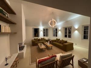a living room with a couch and a table at Chambre d'hôtes Hôte des Portes Île de Ré in Les Portes