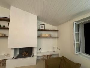 a living room with a fireplace and a couch at Chambre d'hôtes Hôte des Portes Île de Ré in Les Portes