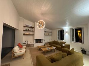 a living room with a couch and a table at Chambre d'hôtes Hôte des Portes Île de Ré in Les Portes