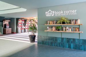 a lobby of a book center with books on shelves at tent Mojito Suites in Magaluf