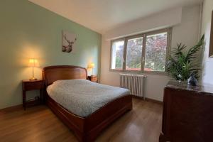 a bedroom with a bed and a window at Clos de la Gare in Tournan-en-Brie +50 photos