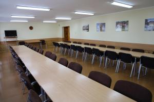 a conference room with rows of tables and chairs at Szkolne Schronisko Młodzieżowe Morena in Osieczna