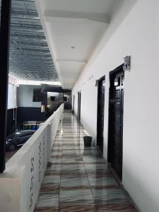 an empty hallway in a building with a long corridor at Hotel Grand Ansara Mentari in Baturaja +11 photos