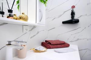a bathroom sink with a red towel on a counter at Arbat Central Apartment in Almaty