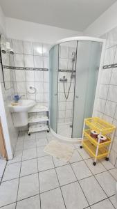 a bathroom with a shower and a sink at Apartmány a penzion Hacienda in Domanín