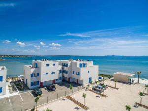 an aerial view of two white buildings next to the ocean at Villa Miri Melon in Privlaka