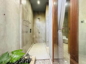 a bathroom with a shower and a toilet at Cozy room J in Uluwatu near beach,by d'ulu villa in Uluwatu