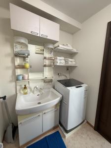 a bathroom with a sink and a washing machine at 朝日街の宿 An inn on Asahi Street in Tokyo +35 photos