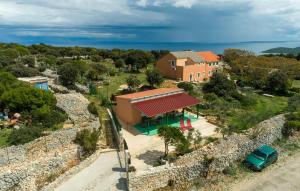 an aerial view of a house next to a wall at 2 Bedroom Beautiful Apartment In Veli Losinj in Veli Lošinj