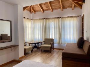 a living room with a couch and a table at Boutique Vila ERI in Gjirokastër