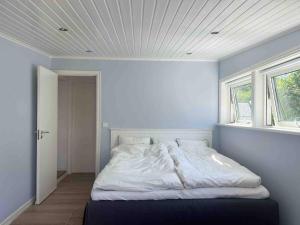 a bed in a room with a window at Villa with spectacular sea view in Öckerö