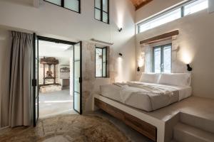 a bedroom with a large bed and a window at Olive Hideaway Boutique Villa - Private Pool - 7 Pax -Pet Friendly in Kalamitsi Amygdali
