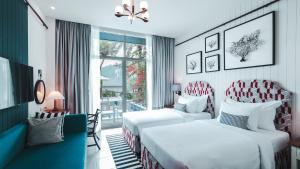 a hotel room with two beds and a window at Sugar Marina Hotel - NAUTICAL - Kata Beach in Kata Beach